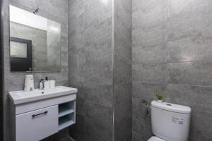 a bathroom with a toilet and a sink and a mirror at Élégant 2BR au cœur de Hassan by MERAT HOME in Rabat +22 photos