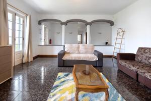a living room with a couch and a table at Pascoal House in Ribeira Grande