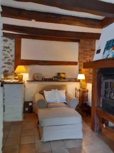 a living room with a couch and a fireplace at Gite Le Pré Des Colombes in Saint-Martin-Sepert +12 photos