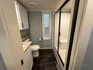 a small bathroom with a toilet and a window at Moon River Mentone 2-A Riverfront Tiny Home in Mentone +22 photos