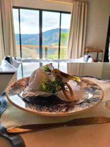 a plate of food sitting on top of a table at Cabana Tesouros do Baú in São Bento do Sapucaí