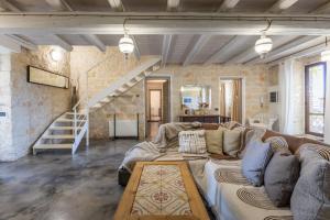 a living room with a couch and a staircase at Villa Antica Aia Relax in Scicli