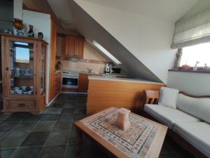 a living room with a couch and a table at Farma Loreta in Vlašim