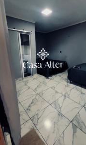 a room with a marble floor and a sign on the wall at Casa alter oficial in Alter do Chao