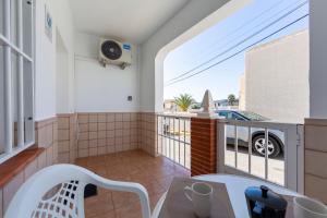 a balcony with a table and a view of a car at Casa Tierra in El Pozo de los Frailes