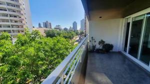 an apartment balcony with a view of a city at Monoambiente encantador en Nuñez in Buenos Aires