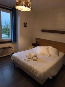 a bedroom with a bed with two towels on it at Le Parc aux Huîtres Hôtel Restaurant in Cayeux-sur-Mer