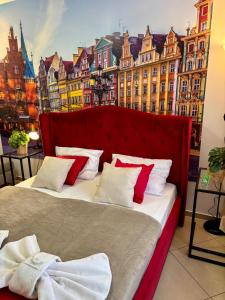 a bedroom with a bed with a view of a city at Great Polonia Wrocław City Center in Wrocław