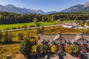 an aerial view of a home with mountains in the background at Riverside Condos by Fernie Central Reservations in Fernie