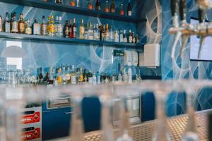 a bar with a lot of bottles of alcohol at Prize by Radisson, Hamburg St Pauli in Hamburg