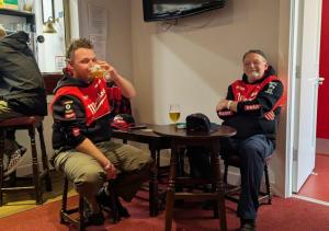 two men sitting at a table drinking wine at Nine Yards Bell Tents at the TT - Castletown in Castletown