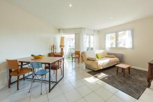 アンデルノ・レ・バンにあるAppartement Thiers in Andernosのテーブルとソファのあるリビングルーム