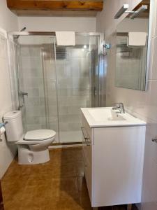 a bathroom with a toilet and a shower and a sink at Villa Moreno in Pollença