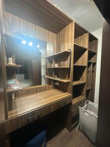 a closet with wooden shelves and a mirror at Hotel Apartment art city compound in Cairo +58 photos