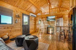 a log cabin with a living room with a fireplace at Panoramic Paradise - Hot Tub in Brookville