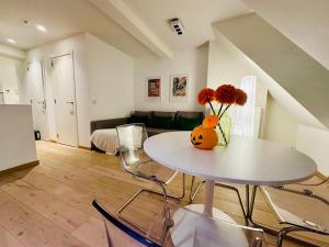 a living room with a table with a vase of flowers on it at The Downtown Experience - 2 BR, Bright, Spacious & Central in Brussels +14 photos