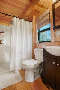 a bathroom with a white toilet and a sink at Panoramic Paradise - Hot Tub in Brookville