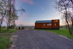 a small wooden house on a gravel road at Panoramic Paradise - Hot Tub in Brookville +6 photos