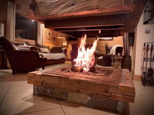 a fireplace in a living room with a fire pit at Chalet Luxury 5-Les Gets-Luxe-confort-jacuzzi-à 400 m des pistes et vue montagne Mont Chéry in Les Gets +36 photos