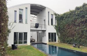 an external view of a house with a swimming pool at Spazio82 in Nizza Monferrato