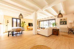 a living room with a couch and a table at Villa Alhena à Lège with heated swimming pool in Lège-Cap-Ferret