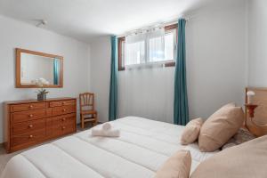 a bedroom with two beds and a dresser and a window at Las Floritas in Playa de las Americas +17 photos