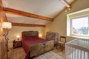 a bedroom with a large bed and a window at Gite de la croix in Apinac