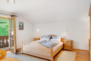 a bedroom with a wooden bed in a room at Ferienwohnung Zugspitznest in Grainau