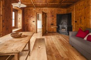 a living room with a table and a fireplace at Josephus - Domicilium II in Madonna