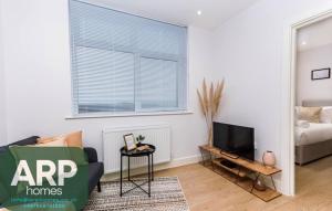 BuckinghamshireにあるElegant Central, Private Parking, Leisure, Contractorのソファとテレビのあるリビングルーム