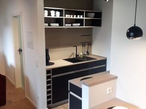 a small kitchen with a sink and a counter at Lieblingsplatz am Kurpark in Brilon
