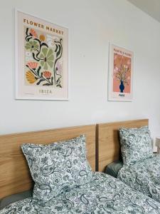 a bedroom with two beds and two posters on the wall at The Downtown Experience - 2 BR, Bright, Spacious & Central in Brussels