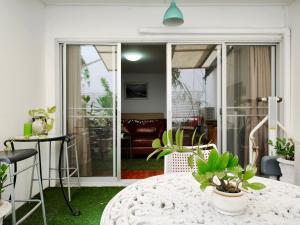 a living room with a table and some plants at Maya Suite in Pratunam