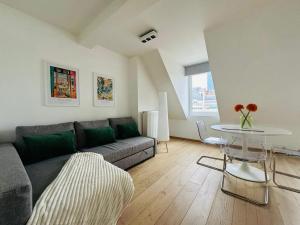 a living room with a couch and a table at The Downtown Experience - 2 BR, Bright, Spacious & Central in Brussels
