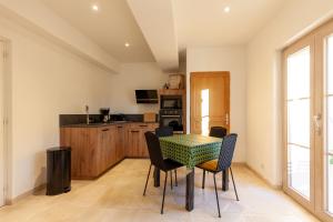 a kitchen with a table and chairs in a room at La Petite Bastide in Sanary-sur-Mer
