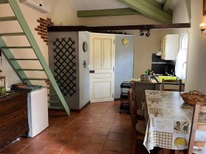 a kitchen with a table and a staircase in a room at Bastidon les Oliviers in Belgentier +17 photos