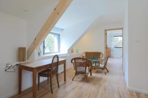 a room with a table and chairs and a staircase at Les Bernaches du Lédano Vue Mer in Paimpol