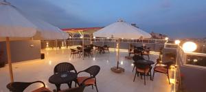 a balcony with tables and chairs on a ship at phoenix Pyramids- roof top in Cairo