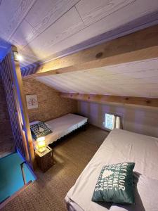 a bedroom with two bunk beds in a house at La Maison Du 146 in Flavin