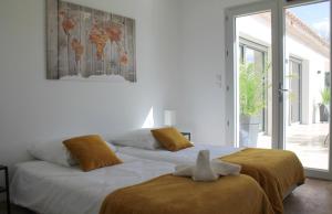 a bedroom with a bed with two stuffed animals on it at La Villa Haute - Maison De Vacances in Mormoiron +24 photos