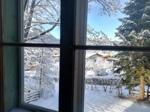 a window with a view of a snow covered yard at Villa Momo in Kitzbühel