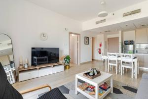 a living room with a large television and a table at F1 - A Place to Stay 1BR Waters Edge Yas Island - Theme Parks in Abu Dhabi