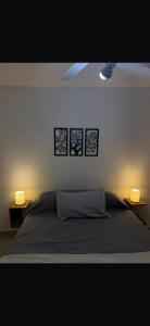 a bedroom with a bed with three pictures on the wall at Apart Boulevard in Vuelta del Paraguayo