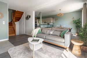 a living room with a couch and a table at Le Cocon des Allamandières in Chonas-lʼAmballan