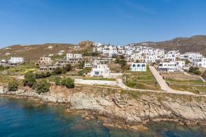 an aerial view of a village on a rocky coast at Lefkopetra in Agios Sostis