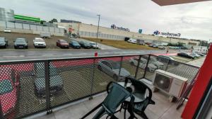 a balcony with chairs and a parking lot with cars at Sika Diplomat Apartment in Arad