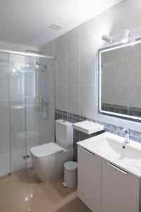a bathroom with a toilet and a sink and a shower at Gold View in Costa Calma +10 photos