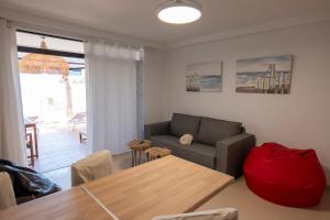 a living room with a couch and a table at Gold View in Costa Calma