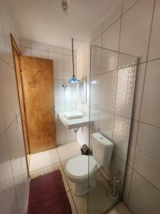 a small bathroom with a toilet and a sink at Casa Vista Mar - Iemanjá in Itacaré +14 photos