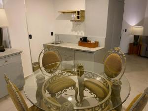 a glass table with three bananas on it in a kitchen at Hotel HBlue Malecón in La Paz +65 photos